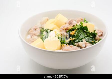 Riso bollito con maiale, foglie di zucca d'edera e tofu morbido Foto Stock