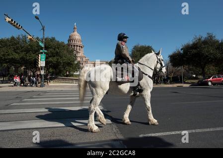 Austin Texas USA, gennaio 18 2016: Un funzionario del dipartimento della pubblica sicurezza del Texas corre sulla pattuglia montata vicino al Campidoglio del Texas. ©Bob Daemmrich Foto Stock