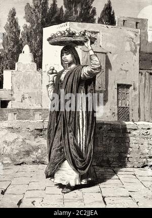 Donna che vende arance su una strada al Cairo, antico Egitto. Illustrazione incisa del 19 ° secolo, El Mundo Ilustrado 1880 Foto Stock