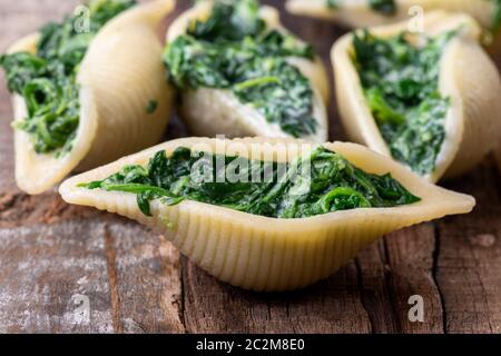 pasta italiana al conchiglino farcita con spinaci Foto Stock