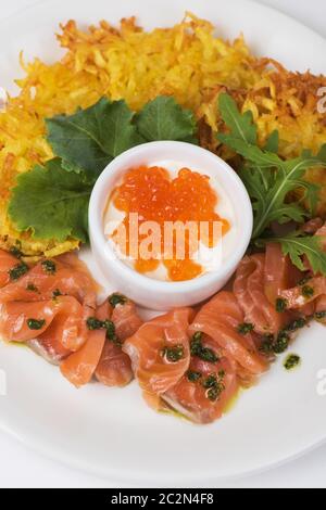 Piastra con frittelle di patate salmone e caviale rosso Foto Stock