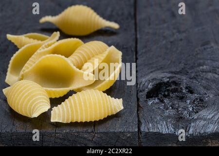 Conchiglione noodle on dark legno rustico. Foto Stock