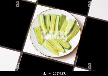 Cetriolo affettato su piatto bianco. Foto Stock