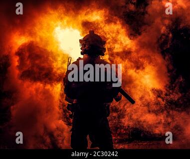 Silhouette di moderno soldato fanteria, combattente dell'esercito d'elite in munizioni tattiche e casco, in piedi con fucile di servizio d'assalto in mani su backgroun Foto Stock