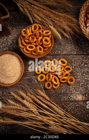 Posa piatta di anelli pretzel su tavola di legno, ancora vita Foto Stock