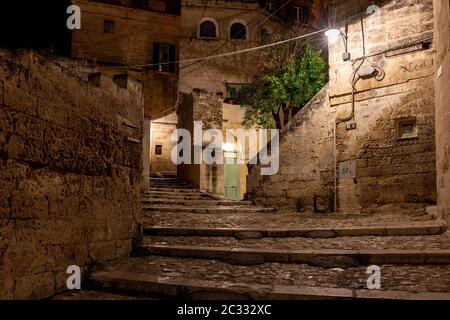 Tipiche scale acciottolate in un vicolo laterale nei Sassi di Matera, un quartiere storico della città di Matera. Basilicata. Italia Foto Stock