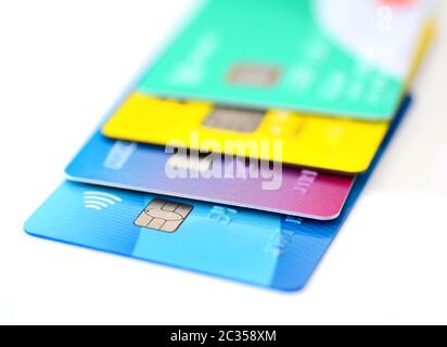 Pila di carte di credito multicolori raccolta su sfondo bianco. Foto Stock