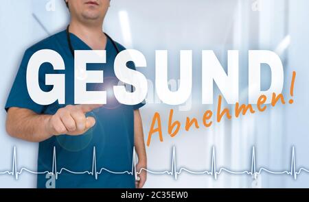 Gesund Abnehmen (in tedesco sana dimagrante) medico mostra sul visore con frequenza cardiaca concetto. Foto Stock