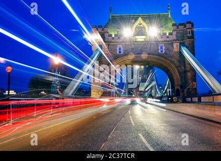I veicoli passano sopra il Tower Bridge attraverso il Tamigi a Londra, Regno Unito Foto Stock