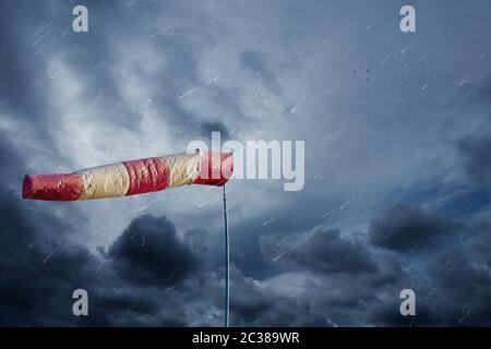 Air sock misura la velocità del vento in caso di pioggia. Hurricane, tornado e tempesta concetto. Foto Stock