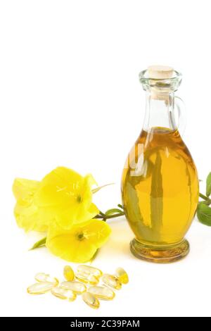 primote serali con capsule di gelatina e flacone di olio su fondo bianco Foto Stock