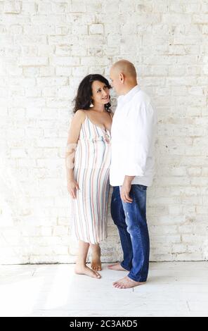 Uomo e donna incinta vicino al muro Foto Stock