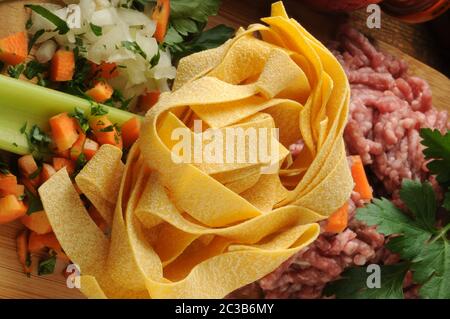 Pappardelle con ingredienti per preparare la salsa. Foto Stock
