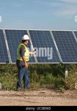 Manor Texas USA, 2012: Bianco maschio utilizza termocamera per eseguire il controllo di qualità e controllare le cellule difettose presso la Webberville Solar Farm, il più grande progetto solare attivo di qualsiasi utilità pubblica nel paese. Ha oltre 127.000 moduli e può generare più di 61 milioni di kWh di elettricità, Texas - 2012. ©MKC / Daemmrich Photos Foto Stock