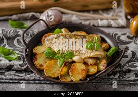 Delizioso pesce con patate arrosto e bio aglio Foto Stock