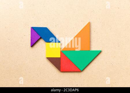 Puzzle tangram colore in forma di cigno o anatra su sfondo di legno Foto Stock