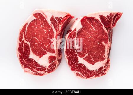 Due bistecche di ribeye disossate appena tagliate su un tavolo da macellaio Foto Stock