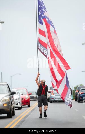 Tulsa, Oklahoma, Stati Uniti. 19 giugno 2020. Randal Thom si accanisce attraverso le strade trafficate di Tulsa con la sua enorme bandiera Trump. Credit: Tyler Tomasello/ZUMA Wire/Alamy Live News Foto Stock