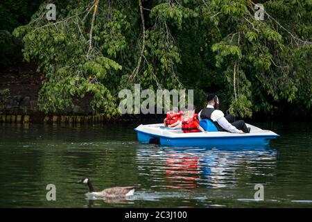 Londra, UK - 17 luglio 2019, una famiglia ebrea ultra-ortodossa sta navigando su un catamarano nel Victoria Park. Bambini in giubbotti di vita Foto Stock