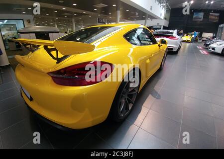 Russia, Mosca - 04 maggio 2019: Porsche Cayman GT4 gialla. Auto da corsa nello showroom del concessionario. Vista posteriore Foto Stock