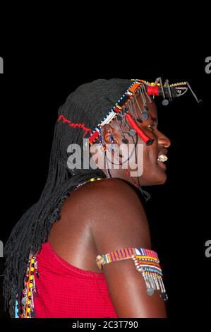 Uomo Maasai sorridente indossando abbigliamento tradizionale, nella Riserva Nazionale di Maasai Mara. Kenya. Africa. Foto Stock