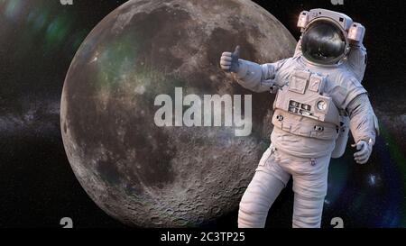 Astronauta che mostra i pollici in orbita della Luna Foto Stock