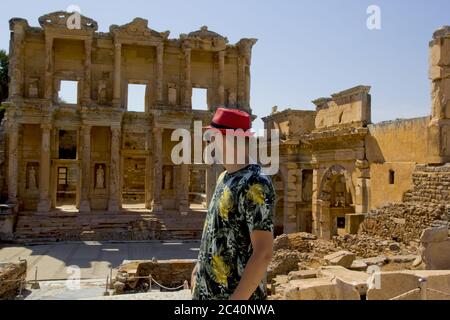 Bel giovane in cappello rosso nell'antica città di Efeso Foto Stock