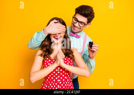 Ritratto due persone uomo chiudere la copertura ragazze occhi tenere chiavi auto acquistare auto vuole dare presente Formalwear rosso punteggiato abito sospetti camicia arco-cravatta isolato Foto Stock