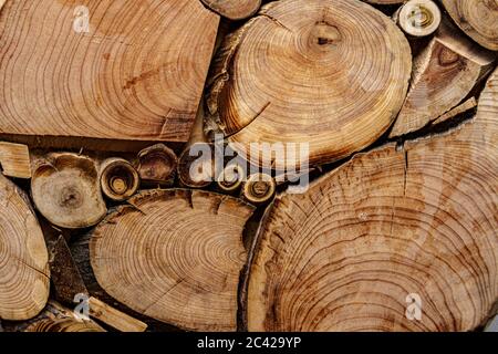 Screensaver, sfondi, texture, concetto di lavorazione del legno - uno sfondo in legno fatto di tronchi di alberi tagliati di diametri diversi sotto forma di A. Foto Stock