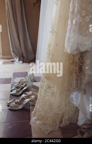 Abiti e scarpe da sposa sul pavimento Foto Stock