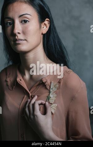 Bella giovane donna che tiene in tasca i fiori Foto Stock