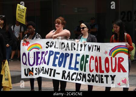 I manifestanti al rally hanno un banner che dice, ‘Solidarità con Queer People of Color. UNSW Anti-Racism Society». Foto Stock