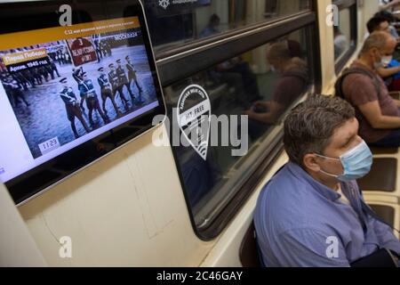 Mosca, Russia. 24 giugno 2020 una trasmissione della parata militare del giorno della Vittoria che segna il 75° anniversario della vittoria nella seconda guerra mondiale su schermi in un treno metropolitano a Mosca, Russia Foto Stock