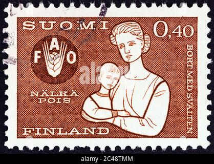 FINLANDIA - CIRCA 1963: Un francobollo stampato in Finlandia dal numero 'Freedom from Hunger' mostra Madre e Bambino, circa 1963. Foto Stock