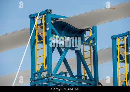 Glasgow, Scozia, Regno Unito. 25 Giugno 2020. Foto: Pale di ventilatore a turbina a vento accatastate in un deposito di tenuta a Govan a Glasgow. Ciò che è speciale di queste pale della ventola è che hanno un bordo di uscita dentellato, che consente la riduzione del rumore del profilo aerodinamico quando la pala taglia attraverso l'aria. Le pale della ventola sulle turbine di grandi dimensioni raggiungono normalmente velocità di circa 120 mph, causando rumore. Poiché il Regno Unito deve rispettare il proprio obiettivo per le energie rinnovabili verdi, la tecnologia svolgerà un ruolo nella riduzione dell'inquinamento acustico delle turbine. Credit: Colin Fisher/Alamy Live News Foto Stock