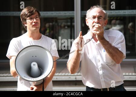 Ian Rintoul della Coalizione per l'azione dei rifugiati parla al raduno contro la deportazione di un richiedente asilo afgano. James flessibile tiene l'altoparlante. Foto Stock