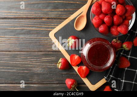 Composizione con marmellata di fragole su sfondo di legno, vista dall'alto Foto Stock