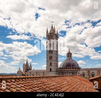 Vista aerea della Cattedrale di Siena con il tetto dell'Opera del Duomo in primo piano. Siena, Italia. Foto Stock