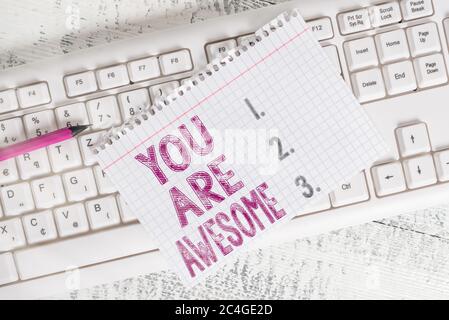 Nota di scrittura che mostra che siete impressionanti. Concetto di business per motivazione, apprezzamento, ammirazione e complimento a qualcuno Keyboard forniture per ufficio re Foto Stock