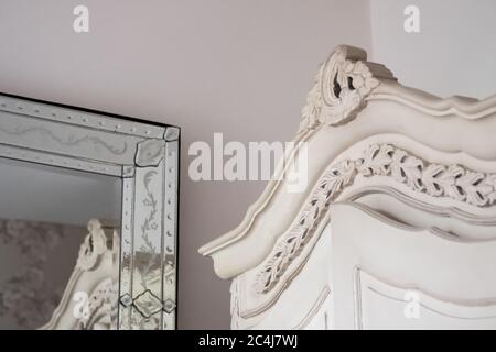 Decorazioni decorate con un grande guardaroba e uno specchio ugualmente ornato visto in un popolare hotel di Londra. Foto Stock