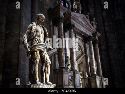 Milano - 16 maggio 2017: Statua di San Bartolomeo fiampata all'interno del Duomo di Milano. Spaventosa statua in interno cupo. Famoso ottenuto Foto Stock