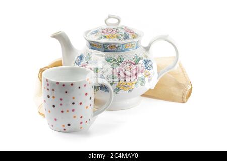 una teiera colorata e una tazza su sfondo bianco Foto Stock
