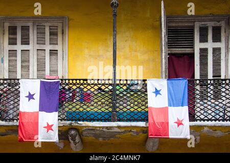 Bandiere di Panama appese ai balconi delle case sotto la luce del sole di giorno Foto Stock