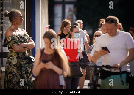 Varsavia, Polonia. 28 Giugno 2020. La gente attende in fila ad un seggio a Varsavia, Polonia, il 28 giugno 2020. Domenica mattina si sono aperte le seggi elettorali per il primo turno delle elezioni presidenziali polacche, che si prevedevano si svolgeranno il 10 maggio ma sono state ritardate dalla pandemia della COVID-19. Il nuovo capo di stato polacco sarà eletto in un periodo di fuga, i sondaggi di uscita del primo turno delle elezioni presidenziali hanno mostrato Domenica sera, ha riferito l'Agenzia Stampa polacca. Credit: Jap Arriens/Xinhua/Alamy Live News Foto Stock