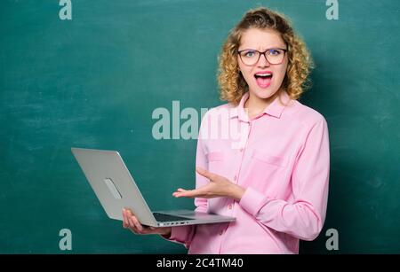 Scuola online. Corso di insegnamento online. Informatica e programmazione. Studiare online. Processo remoto. Notebook per insegnanti che cerca informazioni sfondo lavagna. Donna laptop che naviga in internet. Studente STEM. Foto Stock