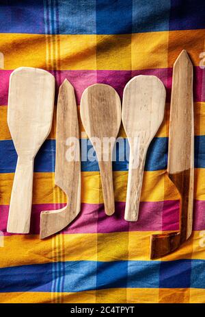 Set di posate in legno del villaggio e utensili da cucina su colorato stile asiatico tessuto vista dall'alto. Foto Stock