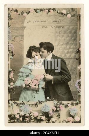 Primo 1900's francese sentimentale tinta saluti scheda - due giovani amanti, ragazza timida 'il primo bacio è sincero', Francia, circa 1911 Foto Stock