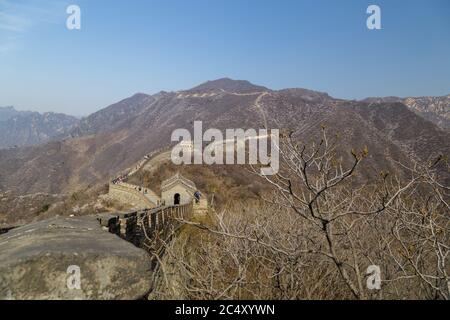 Pechino, Cina - CIRCA 2020: Grande Muraglia della Cina in un paesaggio verde foresta a Mutianyu nel distretto di Huairou vicino a Pechino, Cina. Vista autunnale della grata Foto Stock