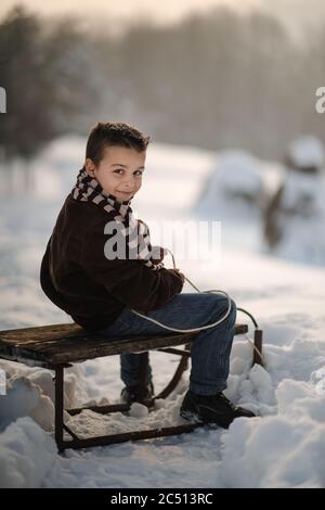 gioie invernali, il ragazzo gioca fuori in inverno Foto Stock