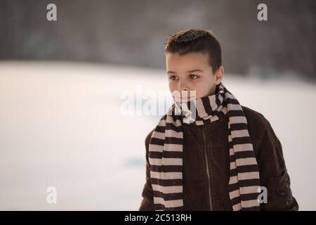 gioie invernali, il ragazzo gioca fuori in inverno Foto Stock